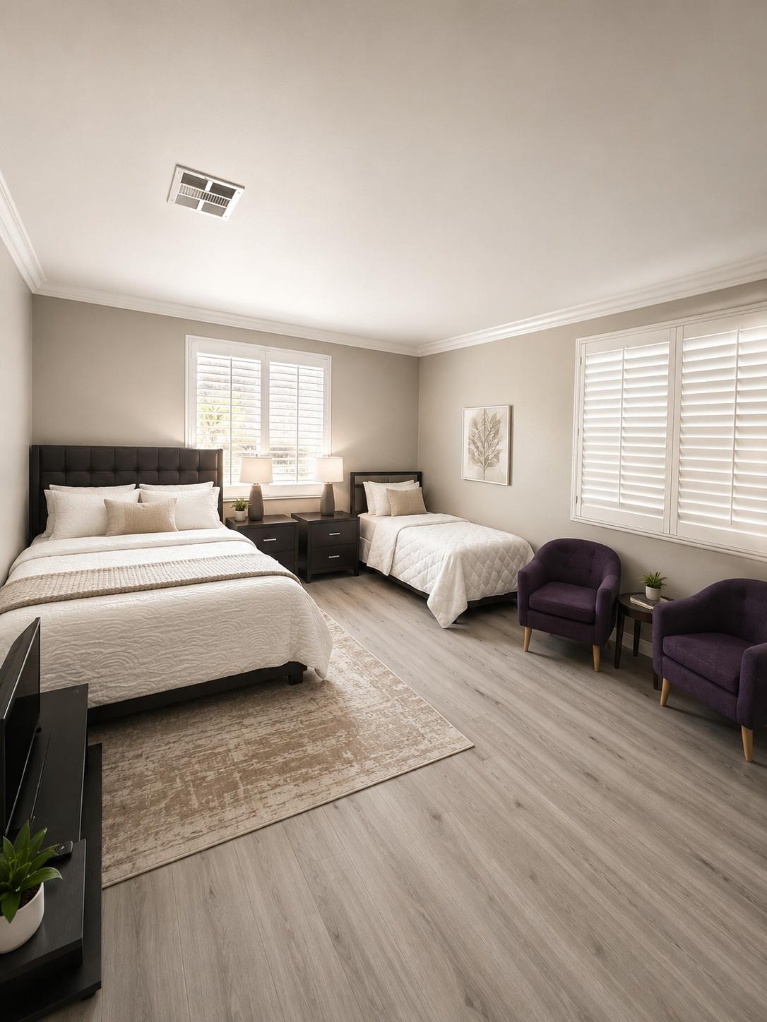 Spacious bedroom with two beds and comfortable seating